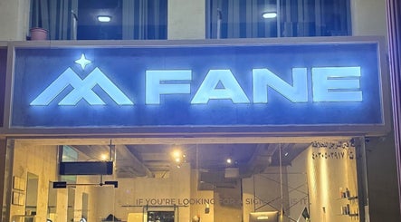 Illuminated sign of Fane Barbershop at night in Jeddah, Makkah Province, SA.