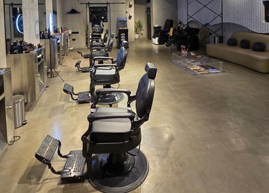 Modern interior of Fane Barbershop in Jeddah, Makkah Province, SA featuring elegant chairs and stylish decor.
