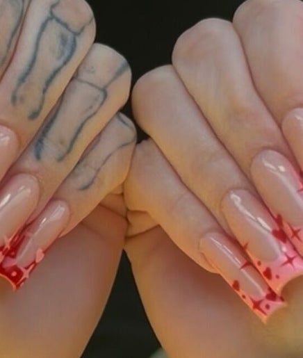 Heart-themed nail art from 5 Star Nails in Marrero, Louisiana, US, showcasing vibrant red and pink designs.