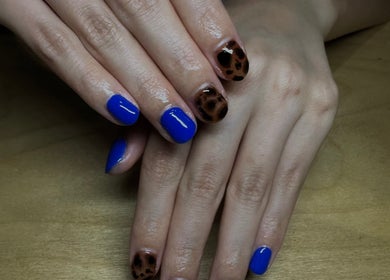 Bold blue and leopard nail art at claw’d studios, Singapore, Singapore, SG, offering stunning nail designs.