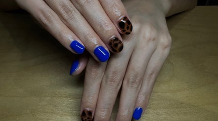 Bold blue and leopard nail art at claw’d studios, Singapore, Singapore, SG, offering stunning nail designs.