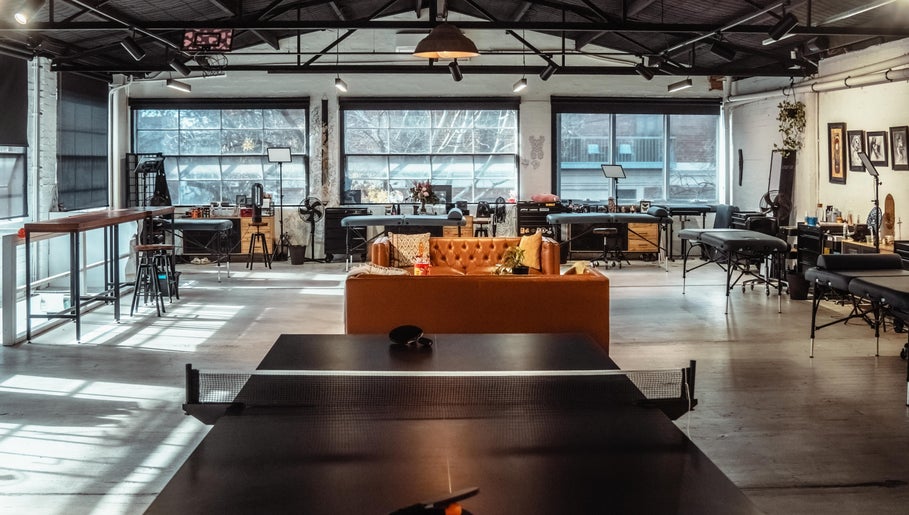 Bright tattoo studio at Umbra Tattoo, Melbourne, Victoria, AU with modern decor and comfortable seating.