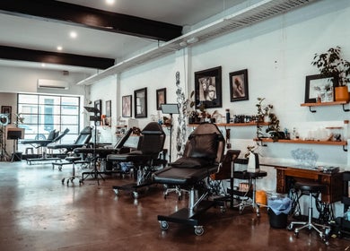 Interior of Umbra Tattoo, a stylish studio in Melbourne, Victoria, AU with modern tattoo stations and art decor.