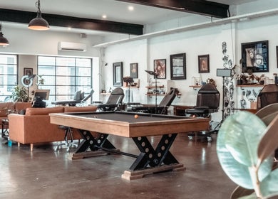 Interior of Umbra Tattoo in Melbourne, Victoria, AU, featuring modern decor and art displays.