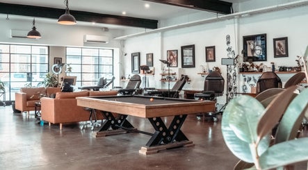 Interior of Umbra Tattoo in Melbourne, Victoria, AU, featuring modern decor and art displays.