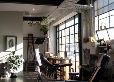 Bright interior of Umbra Tattoo in Melbourne, Victoria, AU, featuring modern decor and tattoo chairs.