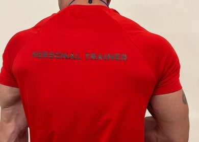 Back of personal trainer in red shirt at Zee Mania, Centurion, Gauteng, ZA.