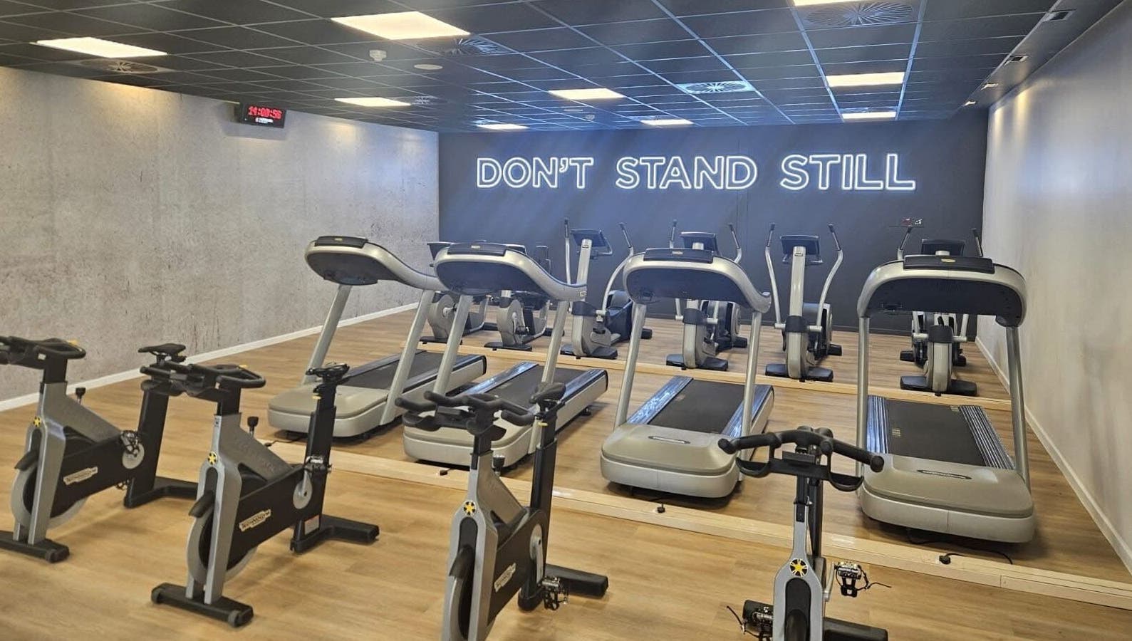 Modern gym at Zee Mania, Centurion, Gauteng, ZA, featuring high-tech treadmills and stationary bikes.