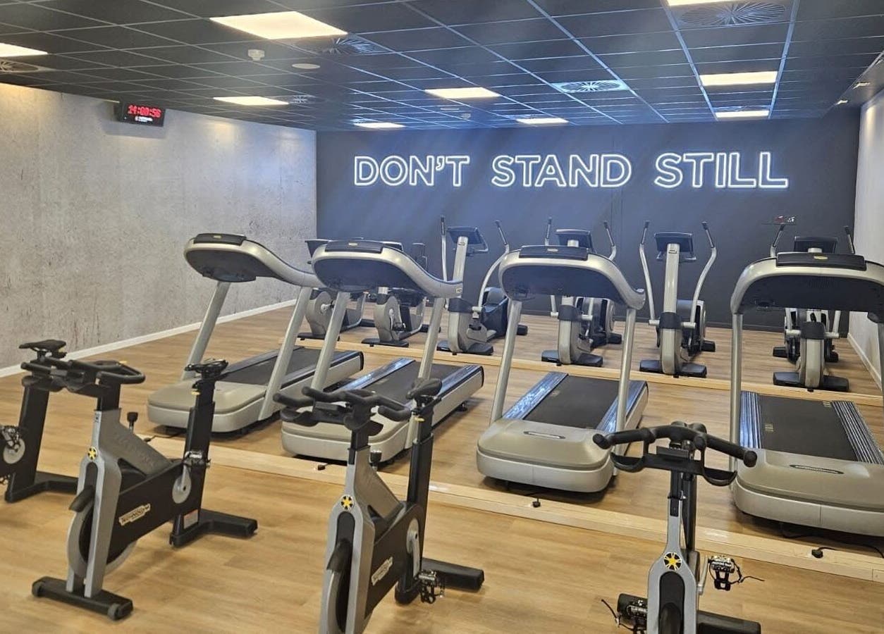 Modern gym at Zee Mania, Centurion, Gauteng, ZA, featuring high-tech treadmills and stationary bikes.