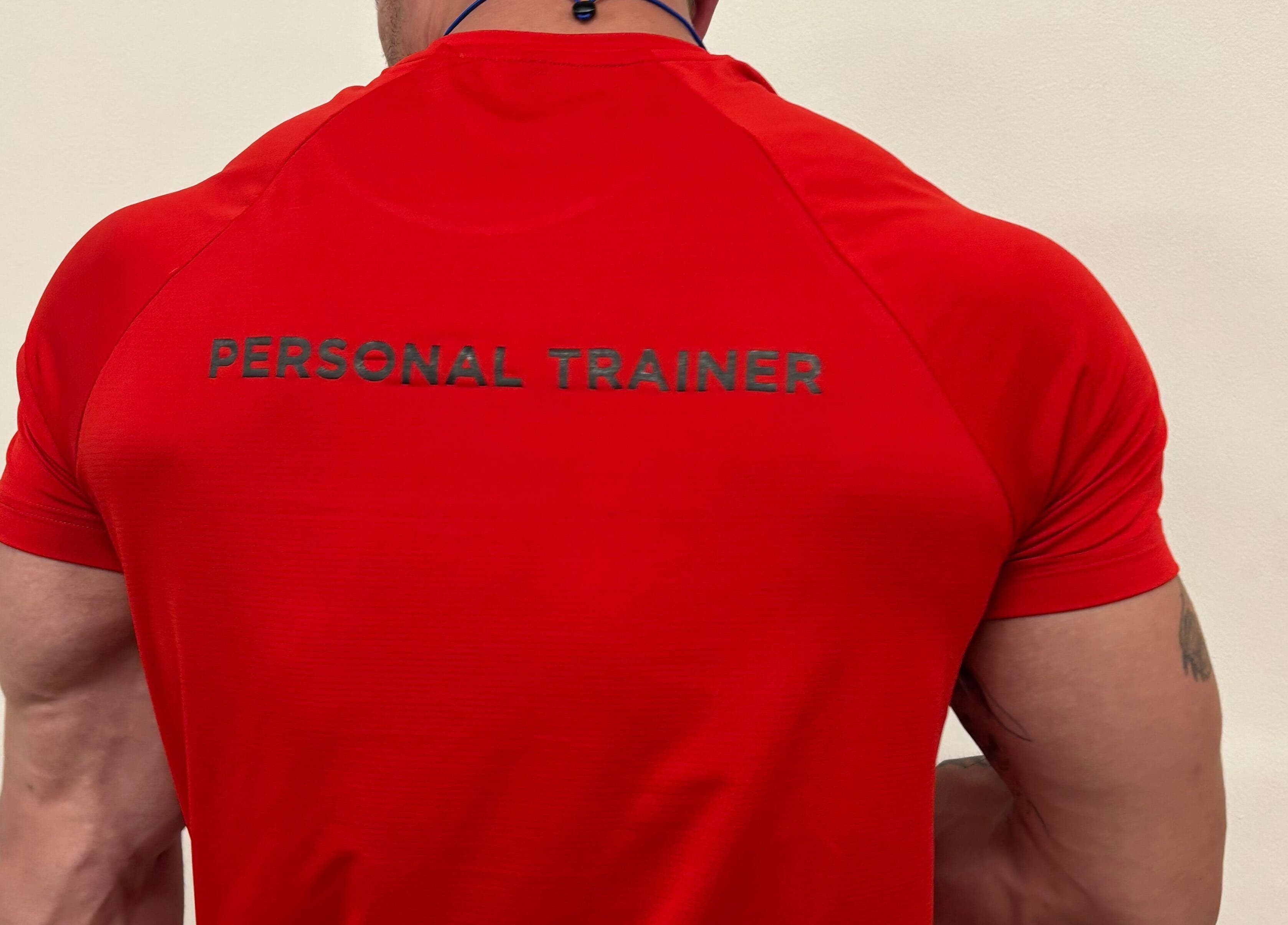 Personal trainer in a red shirt at Zee Mania, Centurion, Gauteng, ZA, ready to guide your fitness journey.
