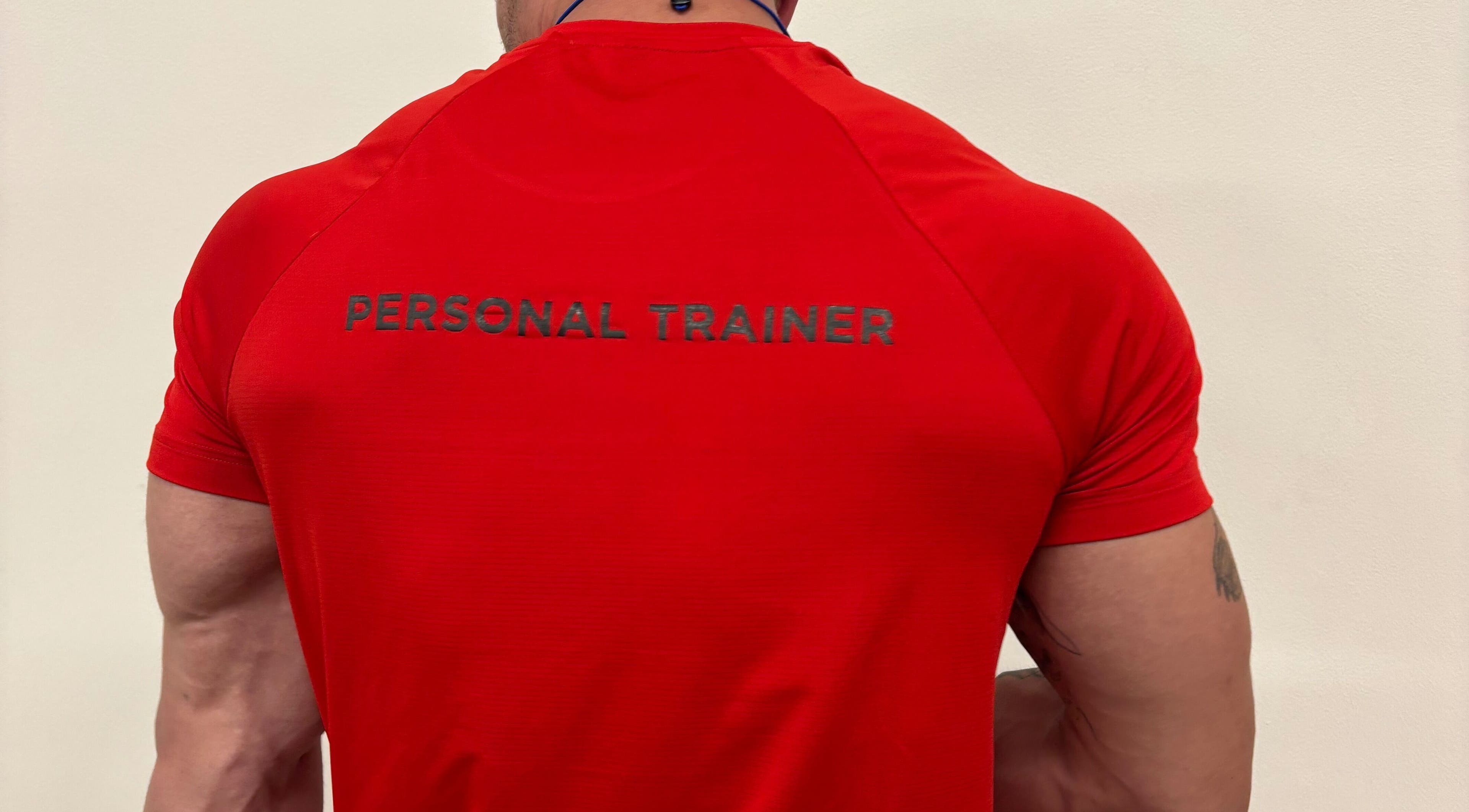Personal trainer in a red shirt at Zee Mania, Centurion, Gauteng, ZA, ready to guide your fitness journey.