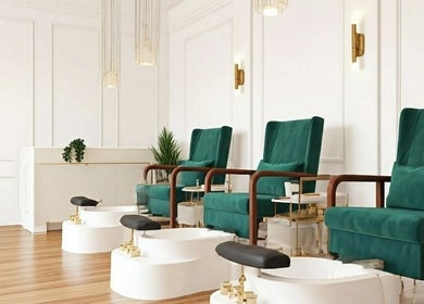 Spacious nail salon at Your Muse, Beirut, Beirut Governorate, LB with plush green chairs and foot baths.