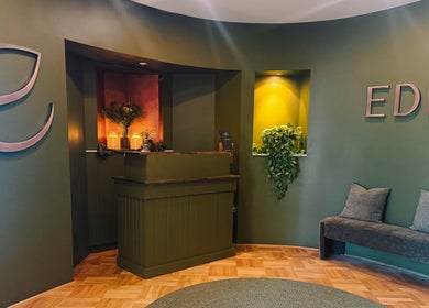 Elegant reception at Eden Massage Studio, East Perth, Western Australia, AU with green decor and cozy seating.