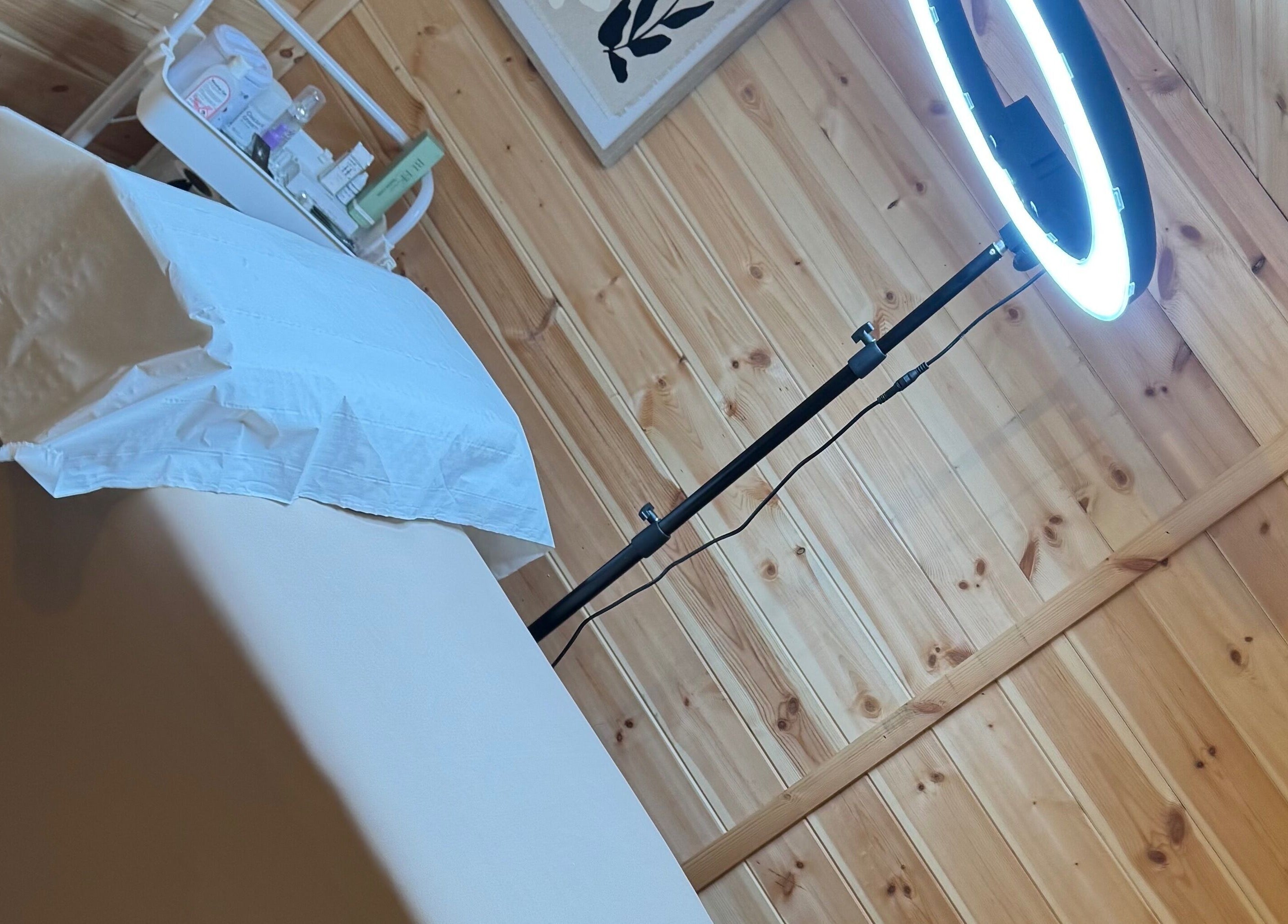 Cozy treatment room at H L Beauty, Poringland, England, GB with a massage bed and soft lighting.