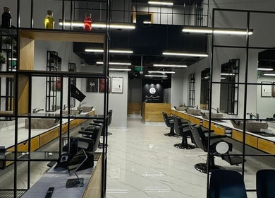 Sleek interior of Yousef Afandi - Hittin Branch in Riyadh, Riyadh Province, SA with stylish salon chairs and decor.