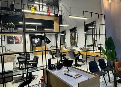 Interior of Yousef Afandi - Hittin Branch, Riyadh, showcasing modern salon chairs and stylish decor.
