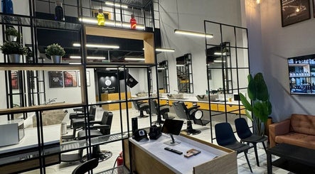 Interior of Yousef Afandi - Hittin Branch, Riyadh, showcasing modern salon chairs and stylish decor.
