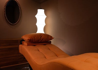Relaxation room with cozy ambiance at Cupid's Club, Singapore, SG, featuring a plush massage table and soft lighting.