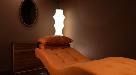 Relaxation room with cozy ambiance at Cupid's Club, Singapore, SG, featuring a plush massage table and soft lighting.
