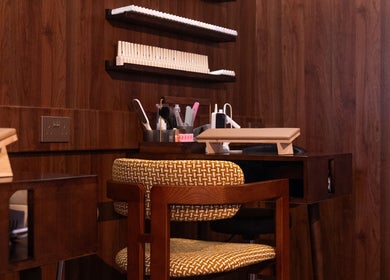 Elegant manicure station at Cupid's Club, Singapore, Singapore, SG with wooden decor and plush seating.