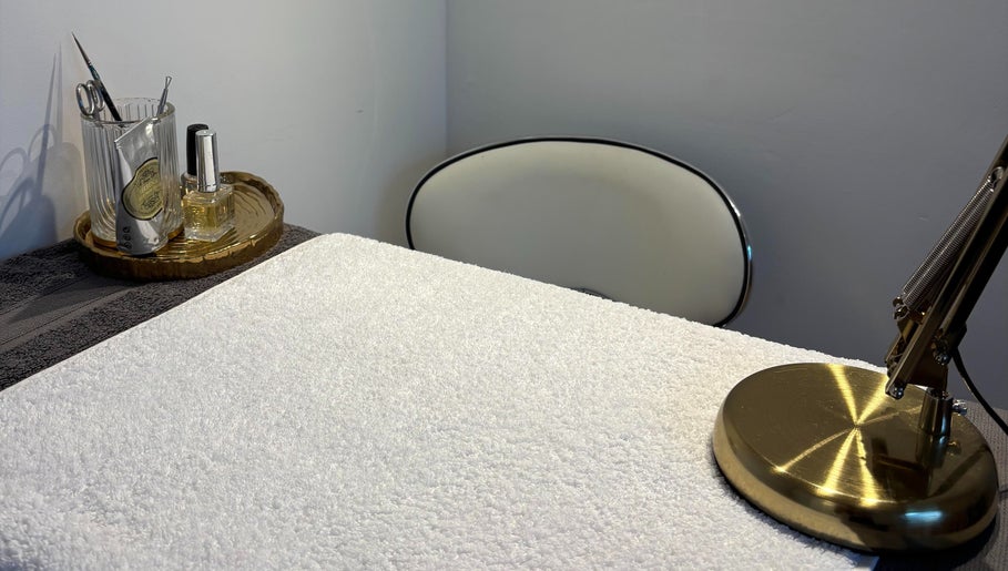 Elegant manicure station at Lumera Beauty, Bromsgrove, England, GB with tools, lamp, and a plush towel.