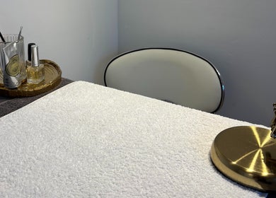 Elegant manicure station at Lumera Beauty, Bromsgrove, England, GB with tools, lamp, and a plush towel.