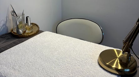 Elegant manicure station at Lumera Beauty, Bromsgrove, England, GB with tools, lamp, and a plush towel.