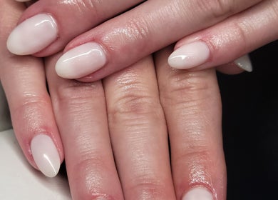 Elegant manicure at Natures Embrace Spa, Madawaska, Ontario, CA showcasing polished white nails.