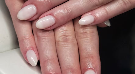 Elegant manicure at Natures Embrace Spa, Madawaska, Ontario, CA showcasing polished white nails.
