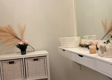 Elegant vanity at Beautybycodiex_ in Warrington, England featuring flowers and decor.