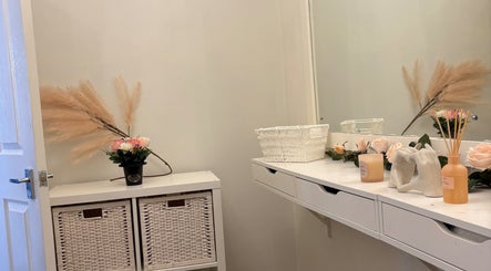 Elegant vanity at Beautybycodiex_ in Warrington, England featuring flowers and decor.