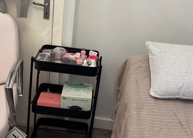 Beautybycodiex_ treatment room in Warrington, England, GB with chair, trolley of products, and cozy bed.