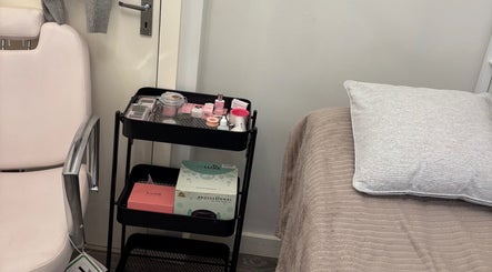 Beautybycodiex_ treatment room in Warrington, England, GB with chair, trolley of products, and cozy bed.