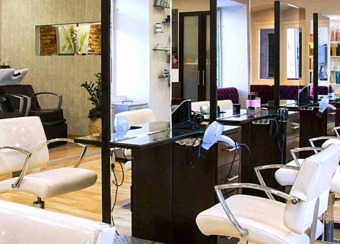 Elegant salon interior at Konstantinos Mourmouris, Κέρκυρα, GR with modern styling chairs and sleek design.