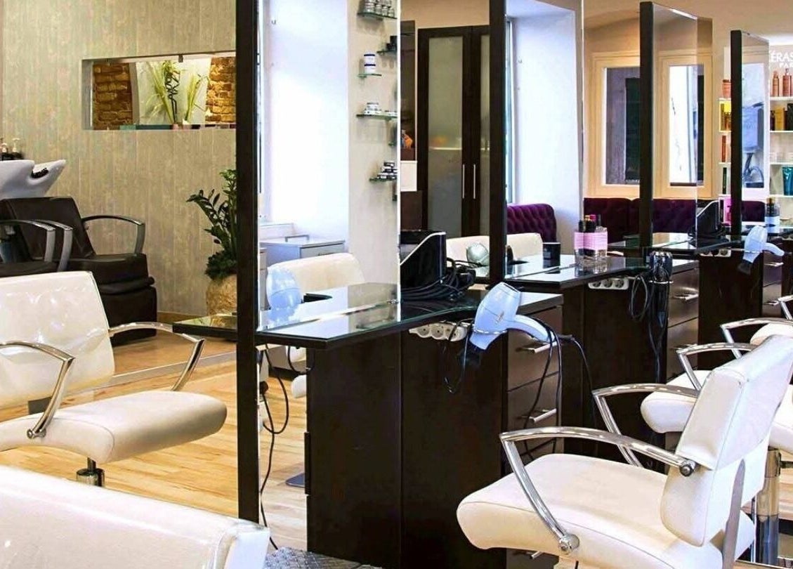 Elegant salon interior at Konstantinos Mourmouris, Κέρκυρα, GR with modern styling chairs and sleek design.