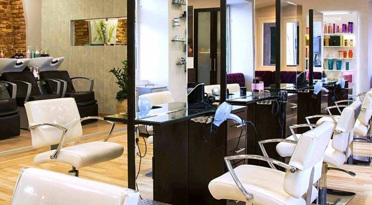 Elegant salon interior at Konstantinos Mourmouris, Κέρκυρα, GR with modern styling chairs and sleek design.