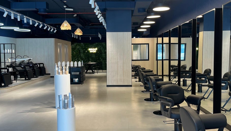 Interior of Hairchef & Dociä Salon LLC in Dubai, AE showcasing modern chairs and stylish decor.