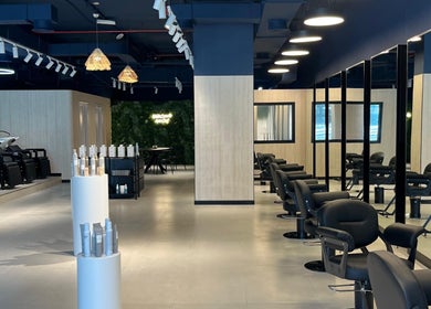 Interior of Hairchef & Dociä Salon LLC in Dubai, AE showcasing modern chairs and stylish decor.