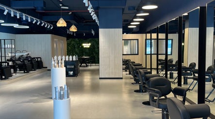 Interior of Hairchef & Dociä Salon LLC in Dubai, AE showcasing modern chairs and stylish decor.