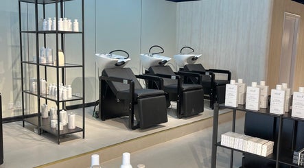 Modern salon interior at Hairchef & Dociä Salon LLC, Dubai, AE with washing stations and product shelves.