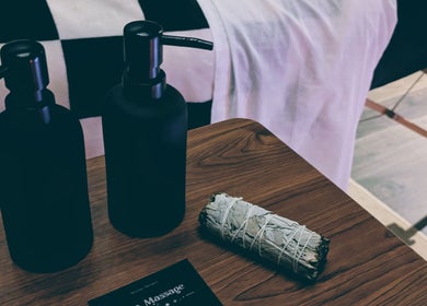 Otta Massage table with oil bottles and sage, Glasgow, Scotland, GB, creating a calming spa atmosphere.