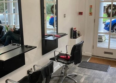 Inside Hollies Beauty Room, Hatfield, England, GB: modern salon chairs, mirrors, and a welcoming atmosphere.