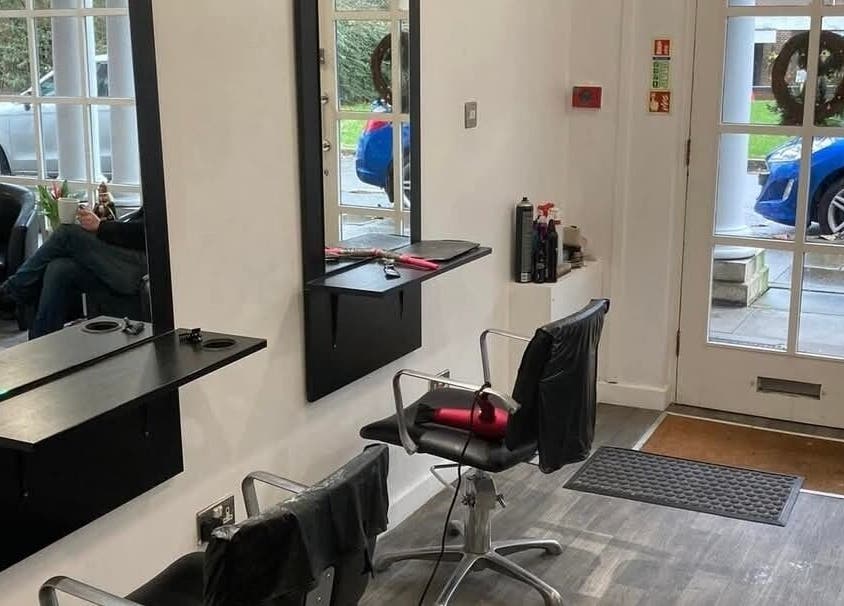 Modern salon interior at Hollies Beauty Room in Hatfield, England, GB showing styling chairs and mirrors.