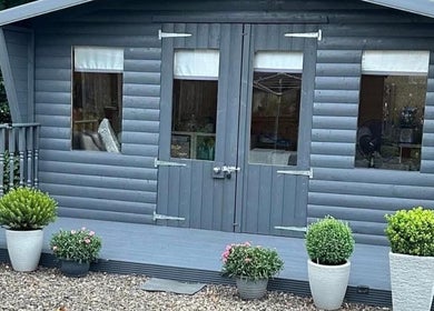 Front view of Kirsty's Beauty Cabin in Cowdenbeath, Scotland with cozy decor and potted plants.