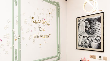 Interior of Maison De Beauté in Doha showcasing elegant decor with floral accents.