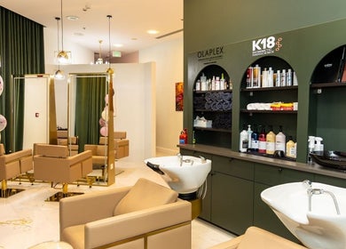 Chic salon interior of Maison De Beauté in Doha, Doha, QA, featuring modern hair styling stations.