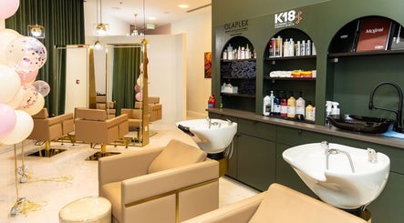 Elegant salon interior at Maison De Beauté, Doha, Doha, QA, featuring plush chairs and styling products.