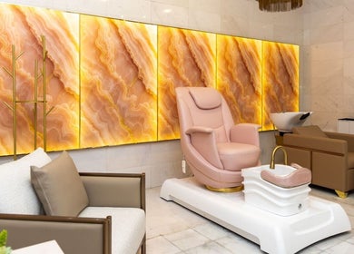 Luxurious pedicure chair at Maison De Beauté, Doha, Doha, QA, with stunning backlit wall panels.