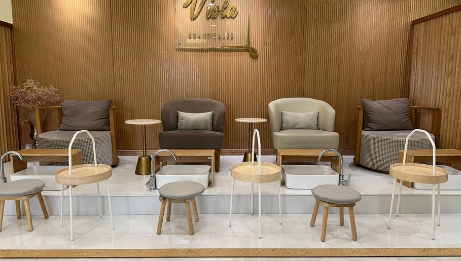 Chic pedicure area at Viola Beauty Salon, Al Mubarraz, Eastern Province, SA, with stylish seating and foot baths.
