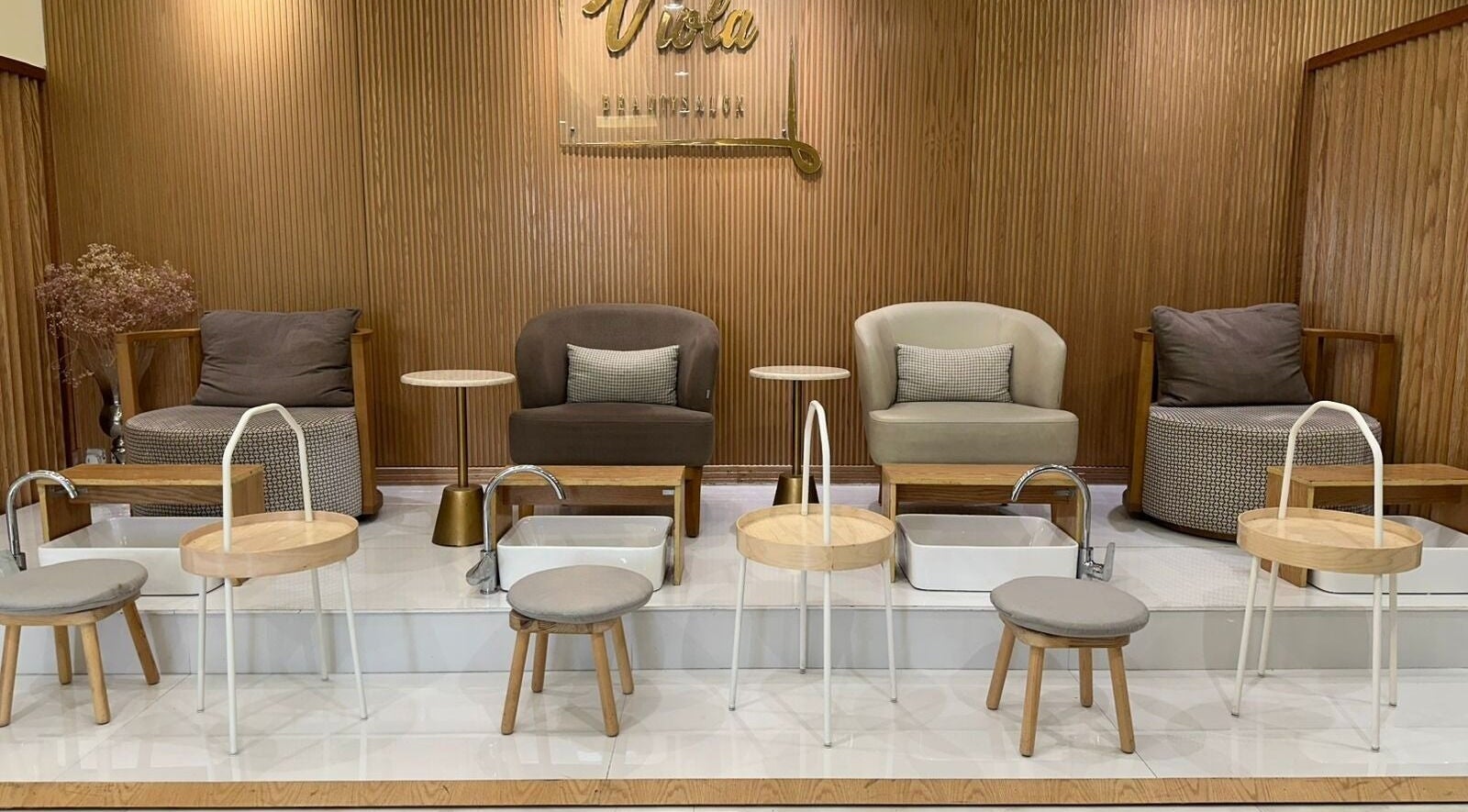 Chic pedicure area at Viola Beauty Salon, Al Mubarraz, Eastern Province, SA, with stylish seating and foot baths.